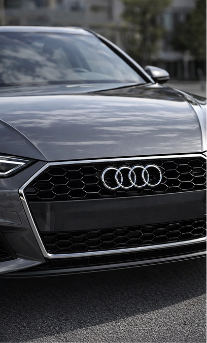 Front grille of a grey Audi, one of the European makes we service